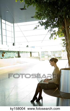 Side profile of a businesswoman working on a laptop View Large Photo Image Picture - Side profile of a businesswoman working on a laptop. Fotosearch