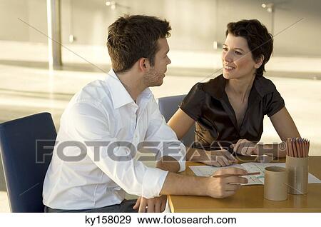 Two interior designers discussing a blueprint View Large Photo Image Stock Photo - Two interior designers discussing a blueprint. Fotosearch