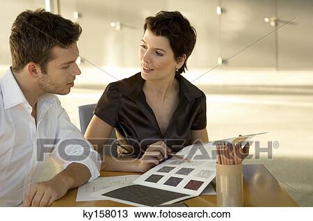 Two interior designers discussing on a color swatch View Large Photo Image Stock Image - Two interior designers discussing on a color swatch. Fotosearch