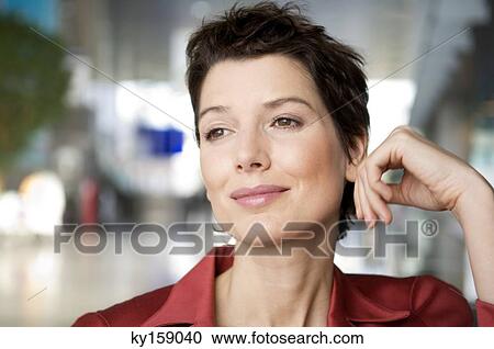 Close-up of a mid adult woman smiling View Large Photo Image Stock Image - Close-up of a mid adult woman smiling. Fotosearch
