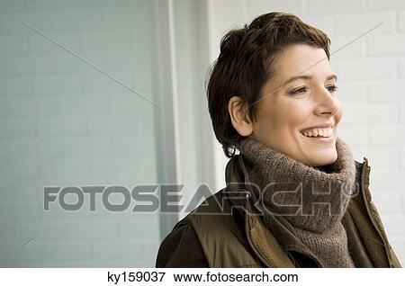 Close-up of a mid adult woman smiling View Large Photo Image Stock Photo - Close-up of a mid adult woman smiling. Fotosearch