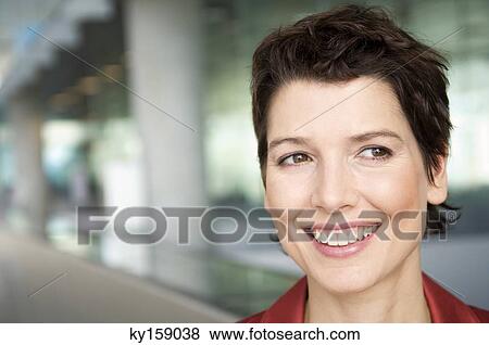 Close-up of a mid adult woman smiling View Large Photo Image Stock Photo - Close-up of a mid adult woman smiling. Fotosearch