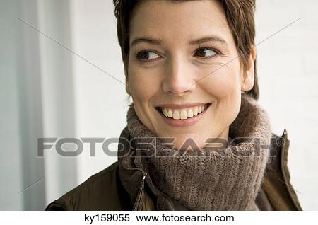 Stock Photography - Close-up of a mid adult woman smiling. Fotosearch