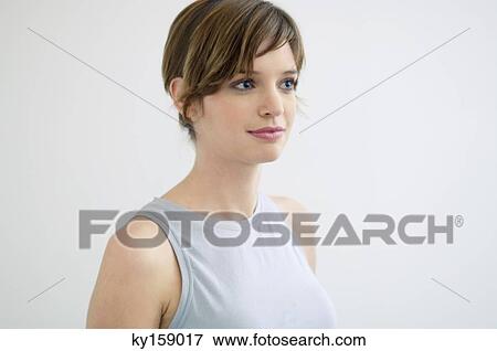 Close-up of a young woman smiling View Large Photo Image Stock Photo - Close-up of a young woman smiling. Fotosearch