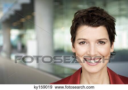 Portrait of a mid adult woman smiling View Large Photo Image Stock Photo - Portrait of a mid adult woman smiling. Fotosearch