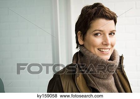 Portrait of a mid adult woman smiling View Large Photo Image Stock Photo - Portrait of a mid adult woman smiling. Fotosearch