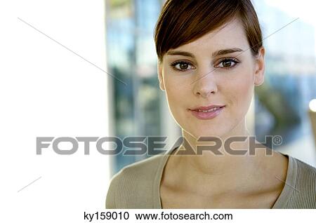 Stock Image - Portrait of a young woman smiling. Fotosearch