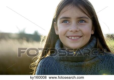 Close-up of a girl smiling View Large Photo Image Stock Photo - Close-up of a girl smiling. Fotosearch