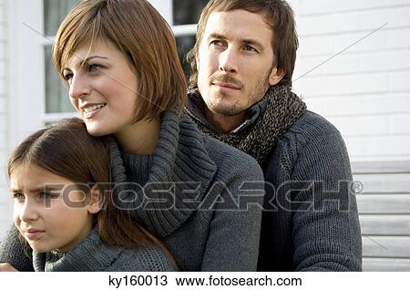 Close-up of a girl with her parents View Large Photo Image Stock Image - Close-up of a girl with her parents. Fotosearch