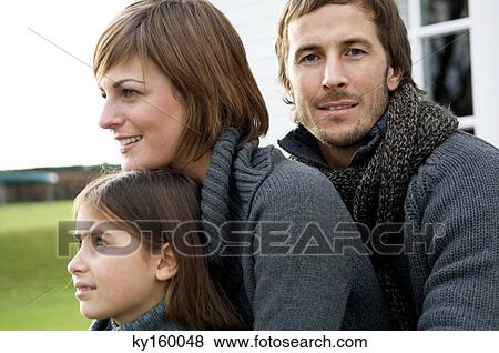 Close-up of a girl with her parents View Large Photo Image Stock Photo - Close-up of a girl with her parents. Fotosearch