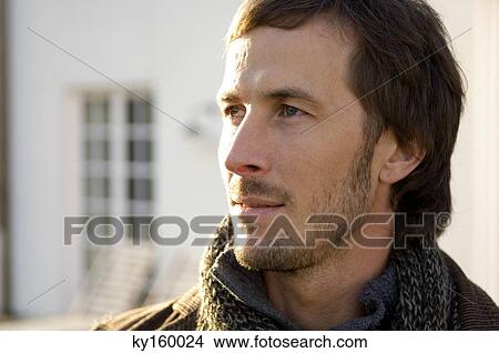 Picture - Close-up of a mid adult man looking away. Fotosearch