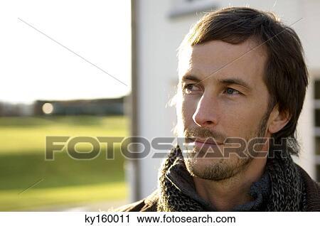 Close-up of a mid adult man looking away View Large Photo Image Stock Image - Close-up of a mid adult man looking away. Fotosearch
