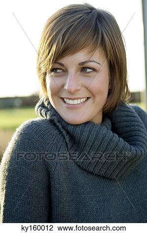 Close-up of a young woman smiling View Large Photo Image Stock Image - Close-up of a young woman smiling. Fotosearch