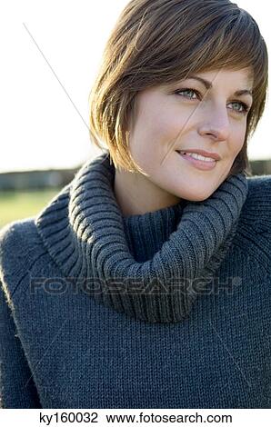 Close-up of a young woman smiling View Large Photo Image Stock Image - Close-up of a young woman smiling. Fotosearch