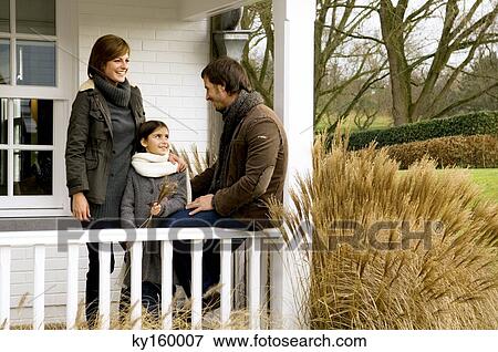 Girl with her parents smiling in a balcony View Large Photo Image Stock Photo - Girl with her parents smiling in a balcony. Fotosearch