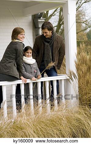 Girl with her parents smiling in a balcony View Large Photo Image Stock Photo - Girl with her parents smiling in a balcony. Fotosearch