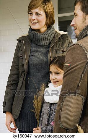 Stock Photo - Girl with her parents smiling. Fotosearch