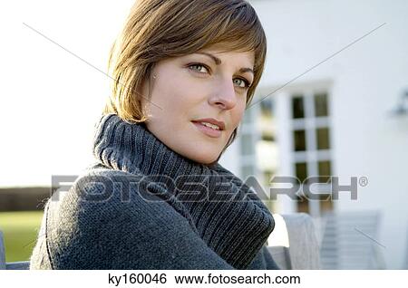 Stock Photograph - Portrait of a young woman smiling. Fotosearch