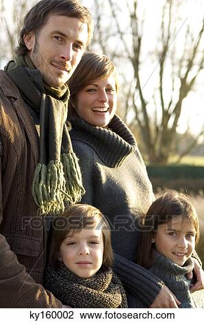 Portrait of two children smiling with their parents View Large Photo Image Stock Image - Portrait of two children smiling with their parents. Fotosearch