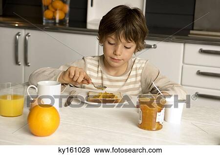Boy having breakfast View Large Photo Image Stock Photo - Boy having breakfast. Fotosearch