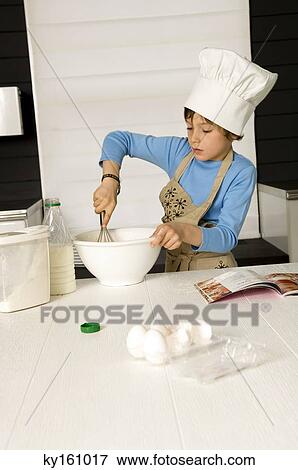 Boy making a cake View Large Photo Image Stock Photo - Boy making a cake. Fotosearch