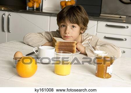 Portrait of a boy having breakfast View Large Photo Image Stock Photo - Portrait of a boy having breakfast. Fotosearch