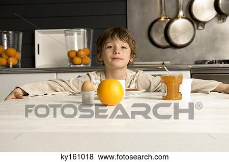 Portrait of a boy having breakfast View Large Photo Image Stock Photo - Portrait of a boy having breakfast. Fotosearch
