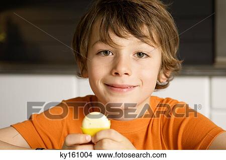 Picture - Portrait of a boy holding cheese. Fotosearch