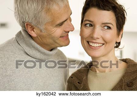 Close-up of a mature man and a mid adult woman smiling View Large Photo Image Stock Image - Close-up of a mature man and a mid adult woman smiling. Fotosearch