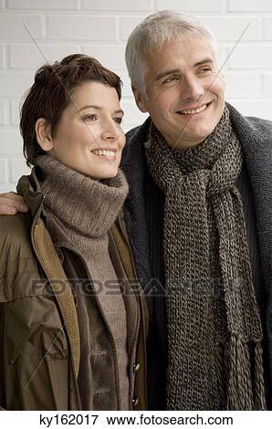 Stock Photo - Close-up of a mature man and a mid adult woman standing. Fotosearch