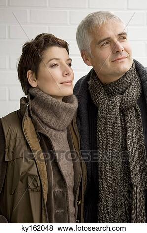 Close-up of a mature man and a mid adult woman standing together View Large Photo Image Stock Photo - Close-up of a mature man and a mid adult woman standing together. Fotosearch