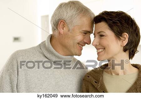 Close-up of a mature man and a mid adult woman romancing View Large Photo Image Stock Photo - Close-up of a mature man and a mid adult woman romancing. Fotosearch