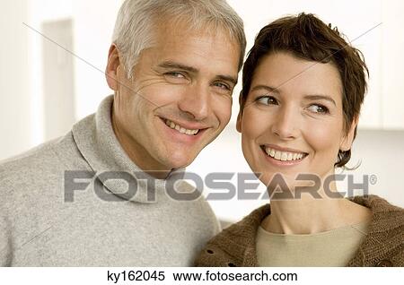 Close-up of a mature man and a mid adult woman smiling View Large Photo Image Stock Photography - Close-up of a mature man and a mid adult woman smiling. Fotosearch