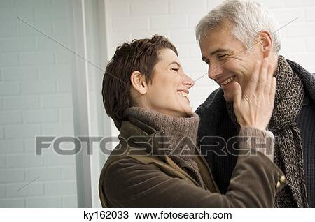 Stock Image - Close-up of a mid adult woman and a mature man romancing. Fotosearch