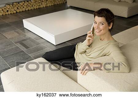 Stock Photo - High angle view of a mid adult woman talking on a mobile phone. Fotosearch