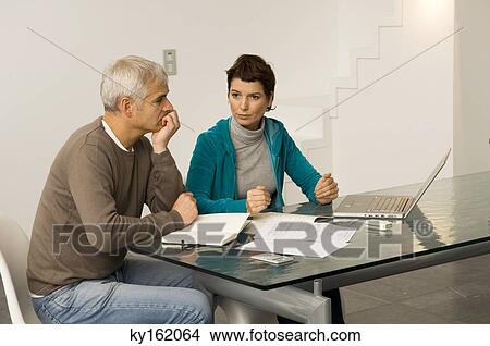 Mature man and a mid adult woman planning their finances View Large Photo Image Picture - Mature man and a mid adult woman planning their finances. Fotosearch