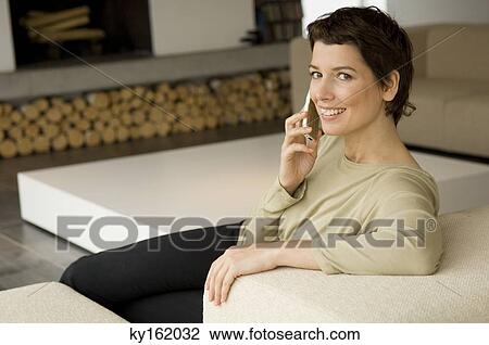 Portrait of a mid adult woman talking on a mobile phone View Large Photo Image Stock Image - Portrait of a mid adult woman talking on a mobile phone. Fotosearch