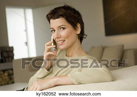 Portrait of a mid adult woman talking on a mobile phone View Large Photo Image Stock Image - Portrait of a mid adult woman talking on a mobile phone. Fotosearch