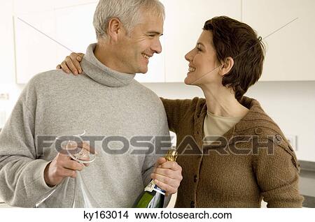 Mature man and a mid adult woman looking at each other View Large Photo Image Picture - Mature man and a mid adult woman looking at each other. Fotosearch