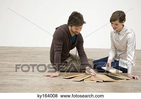 Couple choosing laminated boards View Large Photo Image Stock Photo - Couple choosing laminated boards. Fotosearch