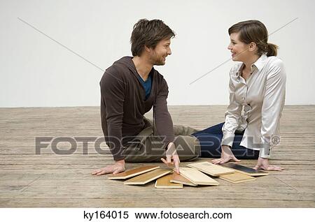 Couple choosing laminated boards View Large Photo Image Stock Photography - Couple choosing laminated boards. Fotosearch