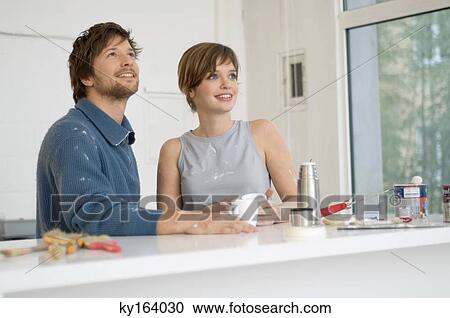 Couple holding cups of tea and smiling View Large Photo Image Stock Image - Couple holding cups of tea and smiling. Fotosearch