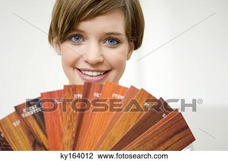 Portrait of a young woman holding laminated boards View Large Photo Image Stock Image - Portrait of a young woman holding laminated boards. Fotosearch