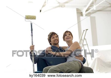 Young woman sitting on the lap of a mid adult man View Large Photo Image Stock Photo - Young woman sitting on the lap of a mid adult man. Fotosearch