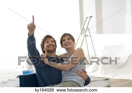 Young woman sitting on the lap of a mid adult man View Large Photo Image Stock Photograph - Young woman sitting on the lap of a mid adult man. Fotosearch