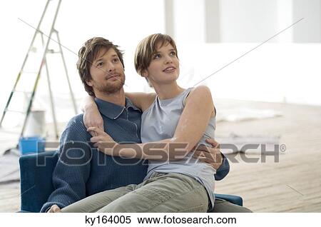 Young woman sitting on the lap of a mid adult man View Large Photo Image Stock Photography - Young woman sitting on the lap of a mid adult man. Fotosearch
