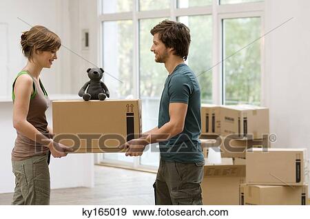 Stock Photo - Couple carrying a cardboard box. Fotosearch