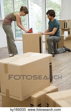 Couple packing cardboard boxes View Large Photo Image Stock Image - Couple packing cardboard boxes. Fotosearch