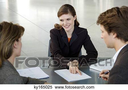 Real estate agent explaining a contract to a couple View Large Photo Image Stock Photography - Real estate agent explaining a contract to a couple. Fotosearch