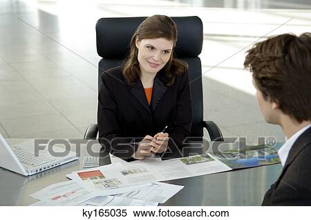 Real estate agent explaining to a young man View Large Photo Image Stock Photography - Real estate agent explaining to a young man. Fotosearch